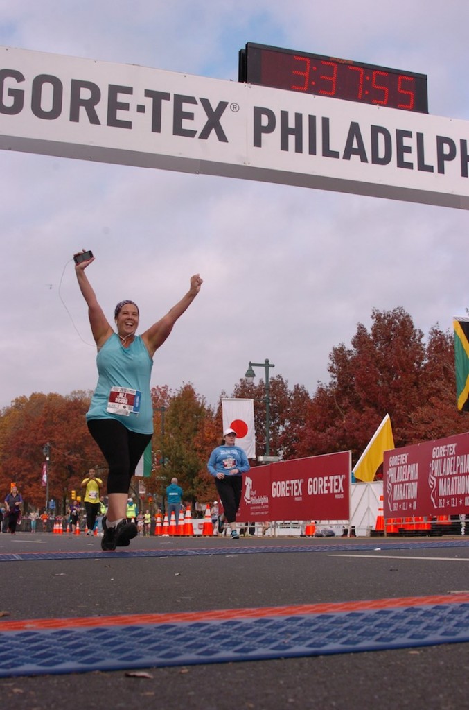 Crossing the finish line of the Philadelphia Half Marathon in 2013. This photo was so meaningful to me that I put it on the cover of my book!